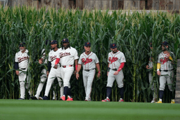 Players walk onto the field before a baseball game between the Minnesota Twins and the Philadelphia Phillies at the Field of Dreams movie site, Thursday, Aug. 13, 2026, in Dyersville, Iowa. (AP Photo/Charlie Neibergall)