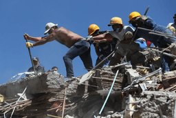 Residents and rescue workers search through the rubble after an earthquake struck Cali, Colombia, Monday, Aug. 10, 2026. (AP Photo/Santiago Saldarriaga)