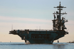 Sailors and Marines line the deck of aircraft carrier USS Abraham Lincoln (CVN-72) as it deploys from San Diego, Jan. 3, 2021. (K.C. Alfred/The San Diego Union-Tribune via AP, File)